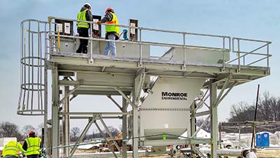 Installation of Vertical Clarifier for disc filter backwash with chemical mix tanks, access platform, ladder, and support structure.