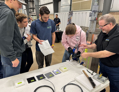 Students try their hand at plastics welding at Monroe Environmental's plastics welding station at a recent career fair