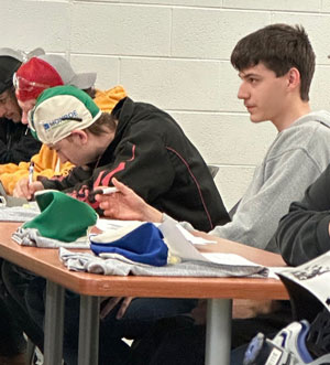 Students listen to a welding presentation