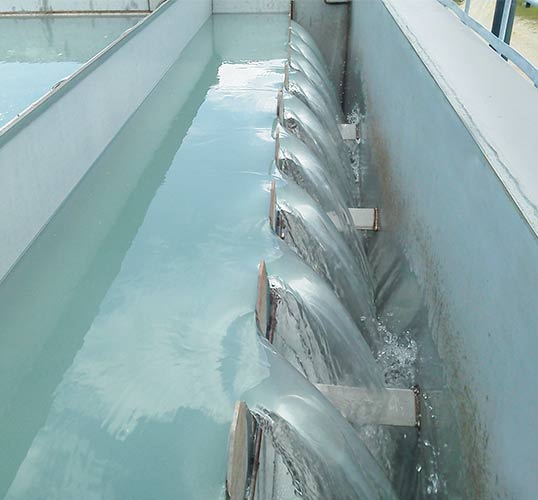 Water flowing from a Horizontal Plate Clarifier’s adjustable weirs. Water flowing from a Horizontal Plate Clarifier's adjustable weirs.
