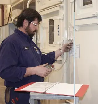 Technician performing equipment testing Technician performing equipment testing