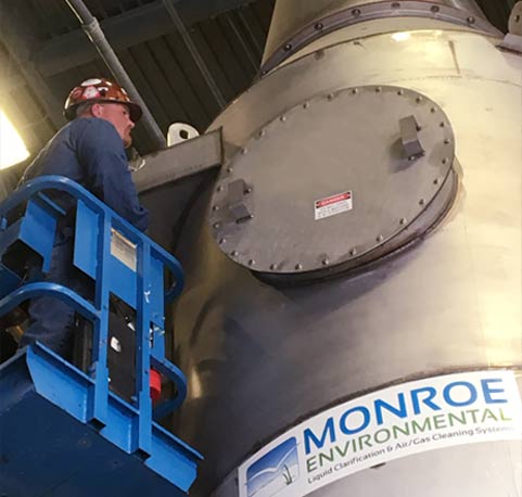 Field service specialist working on a Packed Tower Scrubber Air pollution equipment maintenance by Monroe’s experienced field service staff.