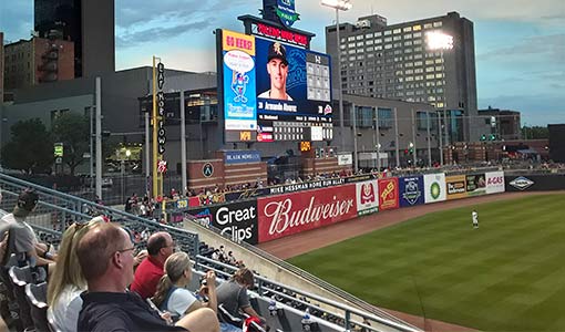 Monroe employees and their families watching a Mud Hens game
