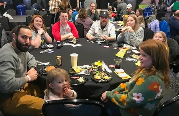 Monroe Environmental employees and their families enjoy the buffet at the Walleye hockey game